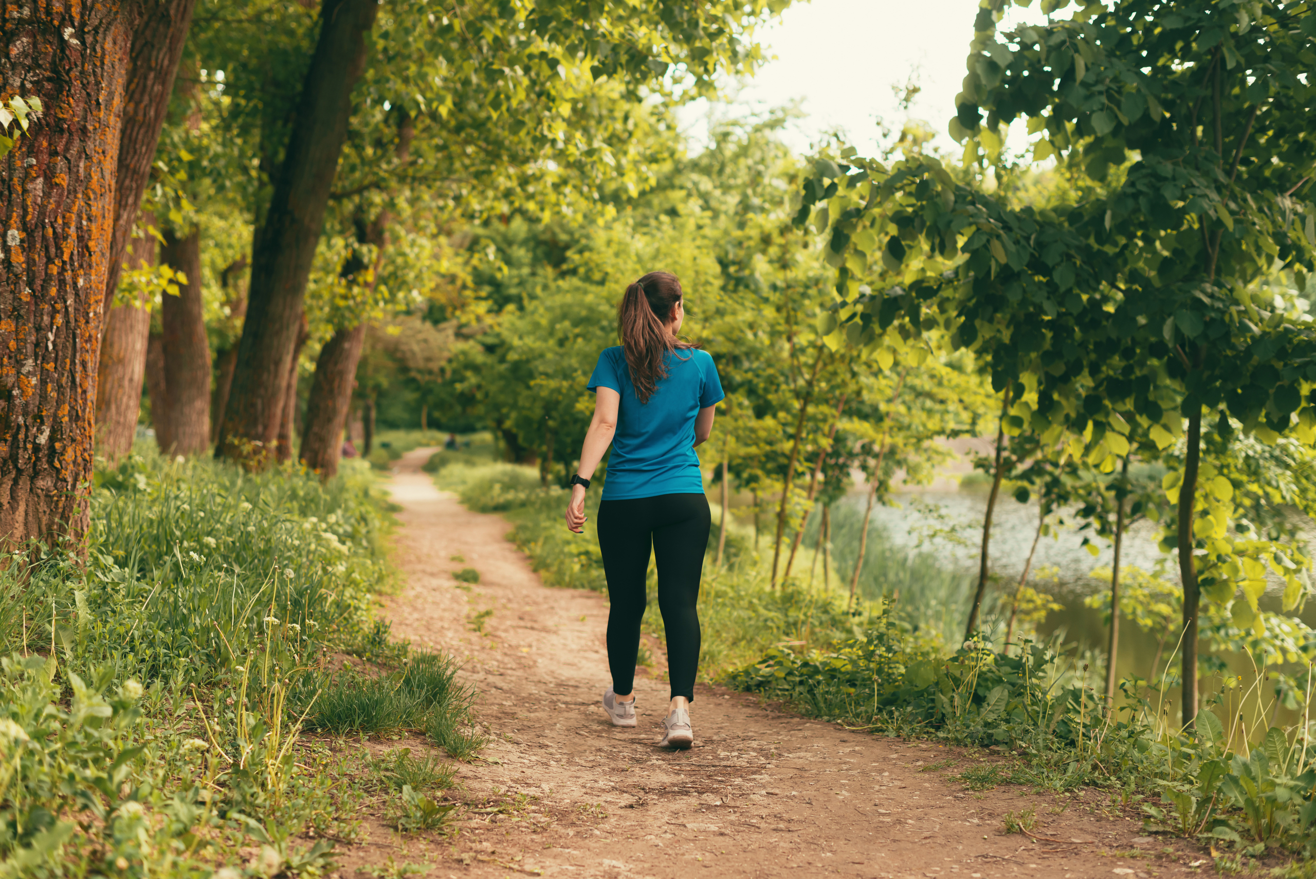 Young woman walking Young woman walking on a path in the forest